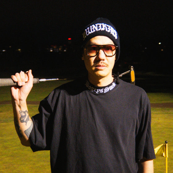 Christopher Yen of Laundry wearing Muni Kids Bogeys Suck Mockneck Golf Shirt