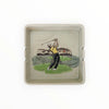 Ceramic tray with a golf-themed design on a white background
