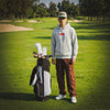 Pedro wearing the Play Your Best Structured Snapback Hat (Khaki/Green) and Bar Logo Hoodie (Grey) with Pin Stripes Golf Headcovers on his golf bag